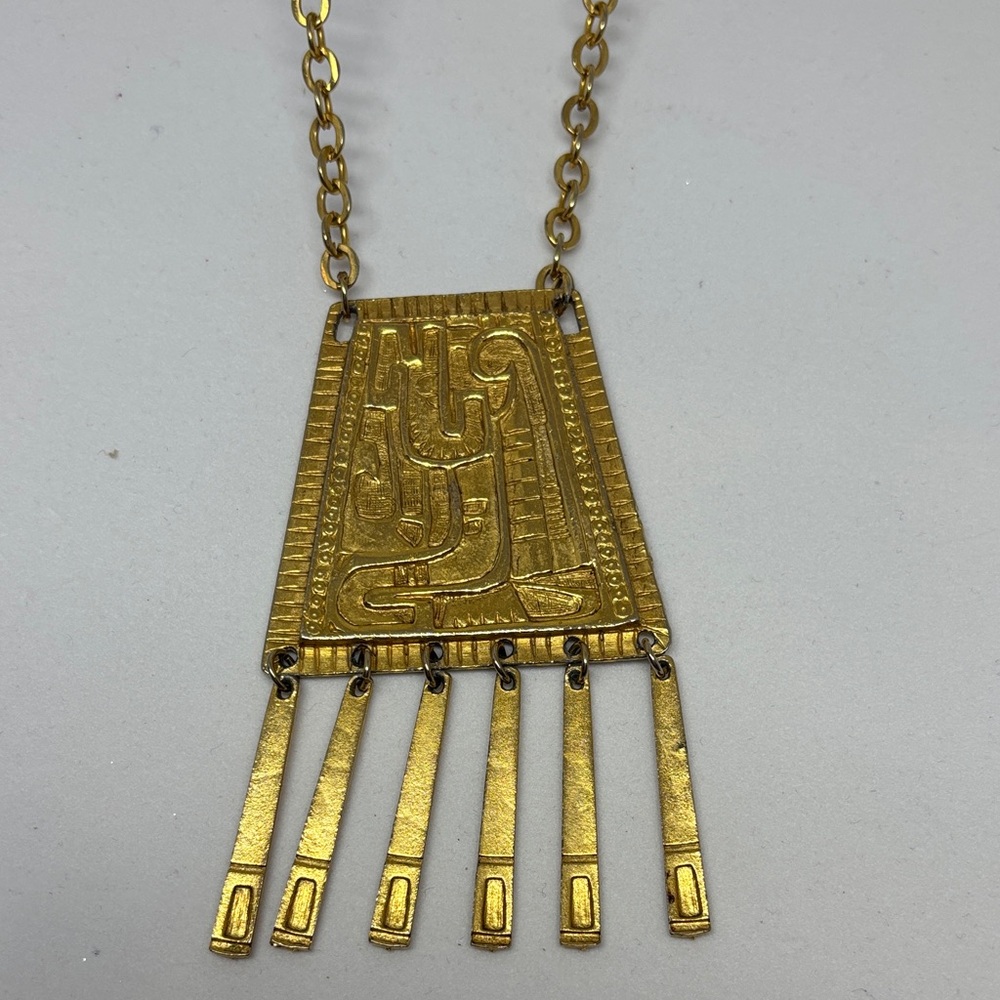 Gold tone, Aztec inspired necklace with large pendant.